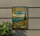 A vintage-style metal sign for the Shadehill State Recreation Area in South Dakota, featuring a scenic landscape with a lake, mountains, and a boat.