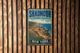 A vintage metal sign for Shadd Moor State Park in New York, featuring a scenic coastal landscape with cliffs and the ocean.