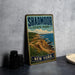 A vintage-style metal sign for Shadmoor State Park in New York, featuring a scenic coastal landscape with cliffs and the ocean.