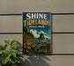 A vintage-style sign for Shine Tidelands State Park in Washington, featuring a scenic landscape with mountains, trees, and a body of water.