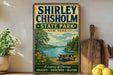 A vintage-style sign for Shirley Chisholm State Park in New York, featuring a scenic image of a lake and forest.