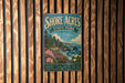 A vintage metal sign for Shore Acres State Park in Oregon, featuring a scenic landscape with mountains, cliffs, and a body of water.