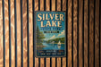 A vintage-style metal sign for Silver Lake State Park in New York, featuring a scenic illustration of a lake with a sailboat and a forested shoreline.