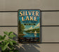 A vintage-style sign for Silver Lake State Park in New York, featuring a scenic image of a lake with a sailboat and a forest backdrop.