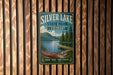 A vintage-style metal sign for Silver Lake State Park in Vermont, featuring a scenic image of a lake, mountains, and a canoe.