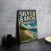 A vintage-style sign for Silver Sands State Park in Connecticut, featuring a beach scene and a bird in flight.