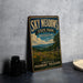 A vintage-style sign for Sky Meadows State Park in Virginia, featuring a scenic landscape with a field of flowers and a wooden fence.
