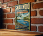 A vintage-style metal sign for Smallwood State Park, Maryland, featuring a scenic image of a lake and a boat on the water.