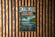 A vintage-style metal sign for Smallwood State Park, Maryland, featuring a scenic landscape with a lake, trees, and a boat on the water.