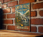 A vintage-style metal sign for Smith Falls State Park in Nebraska, featuring a scenic image of a waterfall surrounded by flowers.