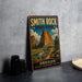 A vintage metal sign for Smith Rock State Park in Oregon, featuring a scenic landscape with mountains, a river, and a path leading through the wilderness.