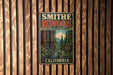 A vintage metal sign for Smithe Redwoods State Natural Reserve in California, featuring a scenic image of the redwood forest.