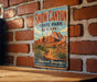 A vintage-style metal sign for Snow Canyon State Park in Utah, featuring a desert landscape with mountains and desert plants.