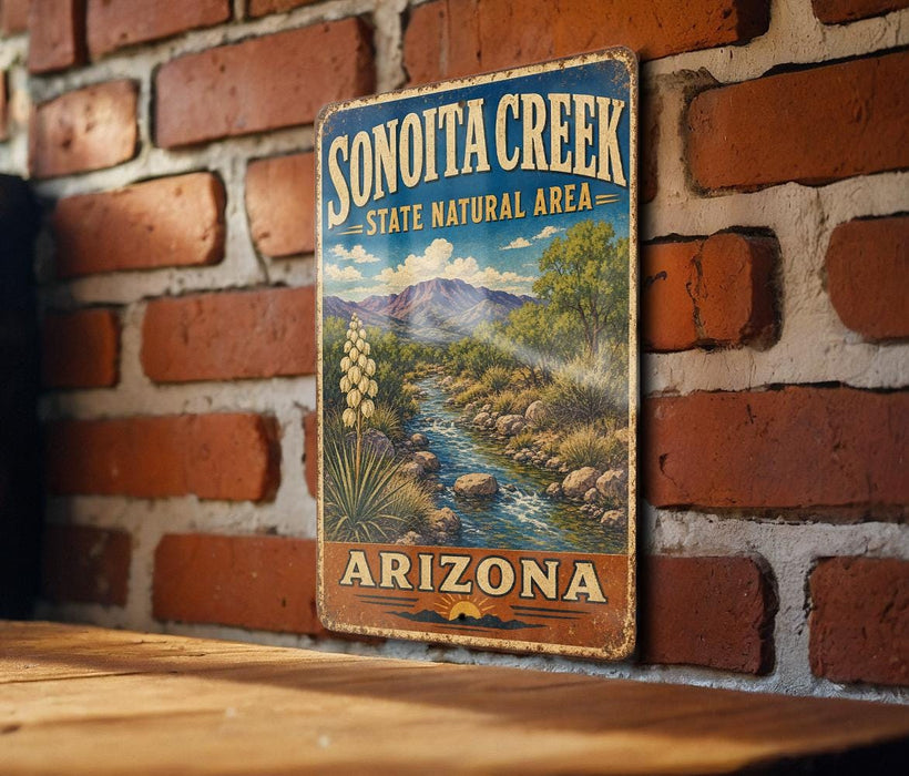 A vintage-style sign for Sonoita Creek, a state natural area in Arizona, is displayed on a brick wall.