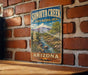 A vintage-style sign for Sonoita Creek, a state natural area in Arizona, is displayed on a brick wall.