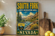 A vintage-style sign for South Fork State Recreation Area in Nevada, featuring a scenic mountain landscape with a river and pine trees.