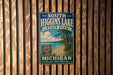 A vintage metal sign for South Higgins Lake State Park in Michigan, featuring a scenic image of the lake and surrounding landscape.