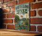 A vintage-style sign for South Llano River State Park in Texas, featuring a scenic illustration of the river and surrounding landscape.