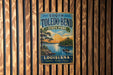 A vintage-style metal sign for South Toledo Bend State Park in Louisiana, featuring a scenic landscape with a lake, trees, and a sunset.