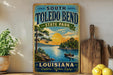 A vintage-style sign for South Toledo Bend State Park in Louisiana, featuring a scenic landscape with a lake, trees, and a boat on the water.