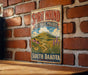 A vintage-style metal sign for Spirit Mound Historic Prairie in South Dakota is displayed on a brick wall.