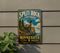 A vintage-style sign for Split Rock Lighthouse State Park in Minnesota, featuring a lighthouse and a scenic landscape.