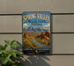 A vintage-style sign for Spring Valley State Park, Nevada, featuring a scenic landscape with mountains, a river, and desert vegetation.