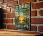 A vintage-style metal sign for St. Bernard State Park in Louisiana, featuring a seagull and a sunset landscape.