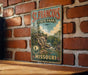 A vintage-style metal sign for St. Francis State Park in Missouri, featuring a scenic landscape with a river and mountains.
