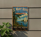 A vintage-style metal sign for St. Mary's River State Park in Maryland, featuring a sailboat on the water and a scenic landscape.