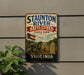 a vintage metal sign for Staunton River Battlefield State Park in Virginia, with a cannon and a monument in the background.