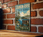 A vintage-style metal sign for Staunton River State Park, featuring a scenic landscape with a lake, trees, and a bird.