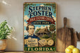 A vintage-style sign for Stephen Foster's Folk Culture Center in Florida, featuring a portrait of a man, a house, and various other elements associated with the Florida state.
