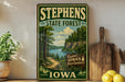 A vintage-style sign for Stephens State Forest in Iowa, featuring a scenic landscape with a river and forest.