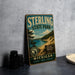 A vintage metal sign for Sterling State Park, featuring a scenic landscape with a lake, mountains, and pine trees.