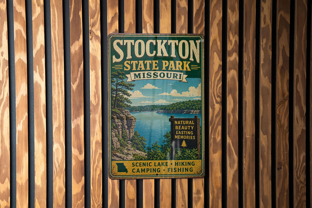 A vintage metal sign for Stockton State Park, Missouri, featuring a scenic lake and mountains in the background.