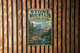 A vintage-style metal sign for Stone Mountain State Park in North Carolina, featuring a scenic mountain landscape and the park's name.