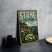 A vintage-style sign for Stone State Park, featuring a scenic landscape with a river and mountains, is displayed on a gray concrete surface.