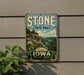 A vintage-style metal sign for Stone State Park, featuring a scenic landscape with a river and mountains.