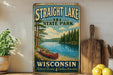 A vintage-style sign for Straight Lake State Park in Wisconsin, featuring a scenic image of a lake with a canoe, surrounded by pine trees and mountains.
