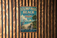 a vintage-style sign for Stump Pass Beach State Park, Florida, with a beach scene and a bird in the background.