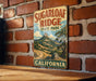A vintage-style metal sign for Sugarloaf Ridge State Park in California, featuring a scenic mountain landscape.