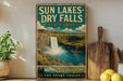 A vintage-style metal sign for Sun Lakes-Dry Falls State Park in Washington, featuring a waterfall and a mountain range.