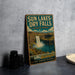 A vintage-style sign for Sun Lakes-Dry Falls State Park in Washington, featuring a scenic image of the waterfall and surrounding landscape.