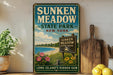A vintage-style sign for Sunken Meadow State Park in New York, featuring a scenic landscape with a beach, flowers, and a sign indicating the location.