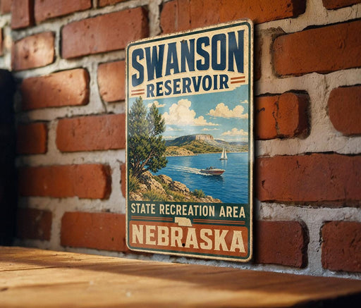 A vintage metal sign for the Swanson Reservoir in Nebraska, featuring a scenic image of a lake and mountains.