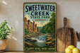 A vintage-style poster of Sweetwater Creek State Park in Georgia, featuring a scenic illustration of the creek and surrounding landscape.