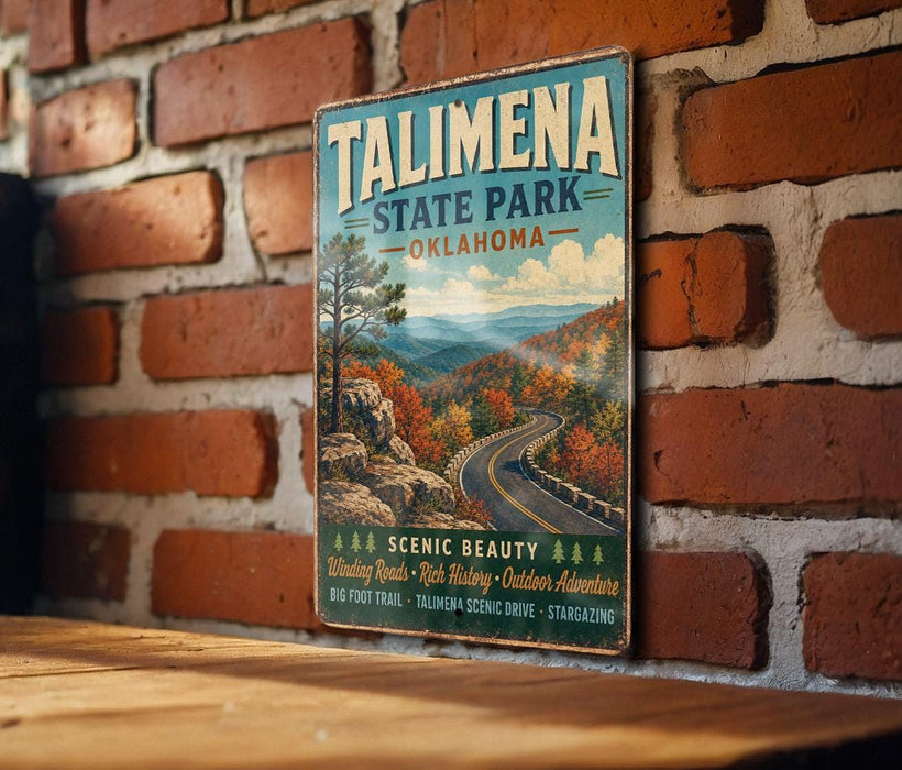 A vintage-style sign for Talimana State Park in Oklahoma, featuring a scenic mountain landscape with winding roads and autumn foliage.
