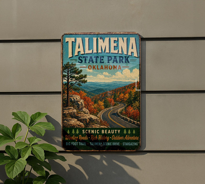 A vintage metal sign for Talimena State Park in Oklahoma, featuring a scenic mountain landscape with winding roads and autumn foliage.