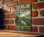 A vintage-style metal sign for Tar Hollow State Park in Ohio, featuring a scenic landscape with a river and forest.